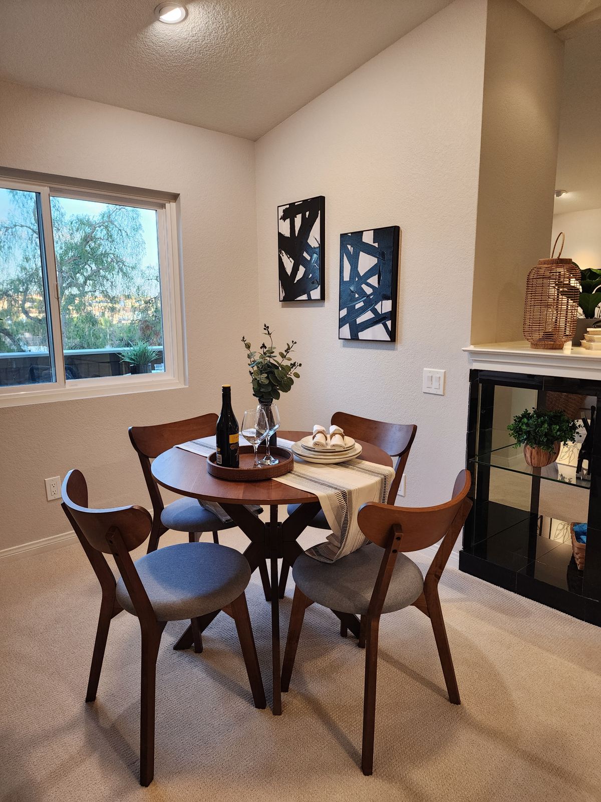 Staged dining nook with mid-century table and art in a Laguna Woods condo
