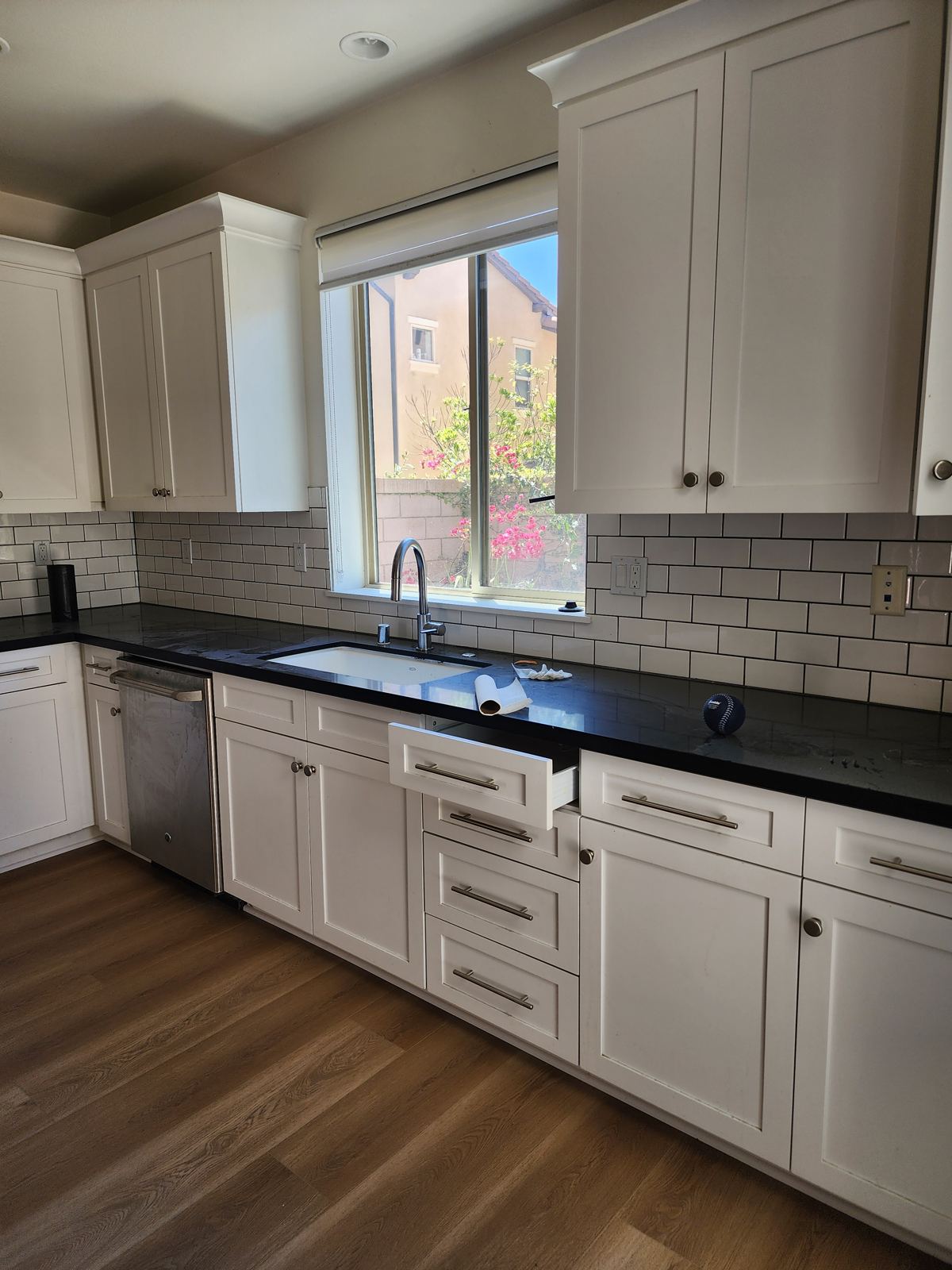 Staged kitchen with white shaker cabinets in a vacant Lake Forest home