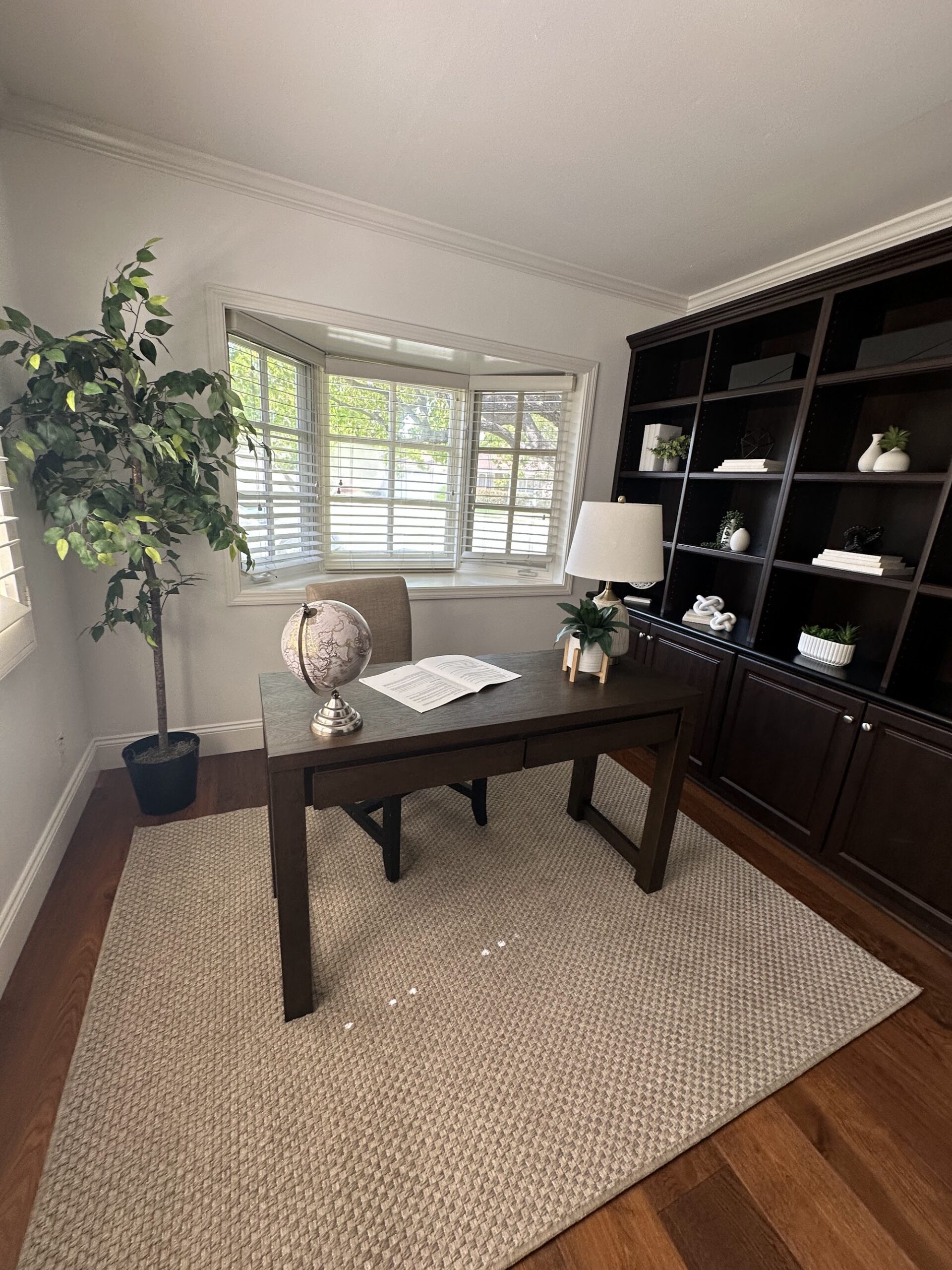 Staged home office with desk, rug and styled built-ins — Irvine home staging by Staging OC
